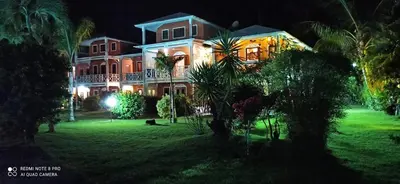 a large house on a lawn at night at Paradise Apartment with senic pool in beach area in El Callejón