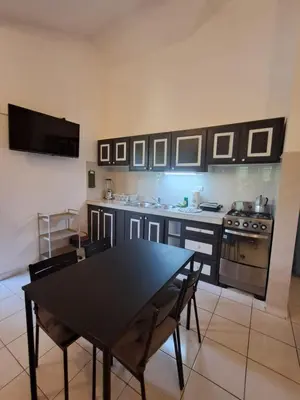 a kitchen with a black table and a stove at Paradise Apartment with senic pool in beach area in El Callejón