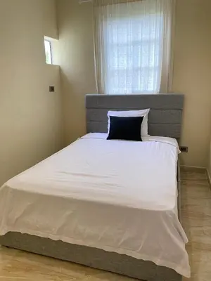 a bedroom with a large bed with a blue pillow at Luxury Apartment By Merengue House in Boca Chica