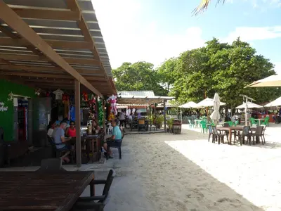 a group of people sitting at tables on the beach at CortLang Vacation Rentals, El Pueblito in San Felipe de Puerto Plata