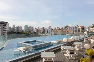 a swimming pool on the roof of a building at Embassy Suites by Hilton Santo Domingo in Santo Domingo