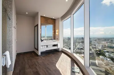 a bathroom with a view of a city at Embassy Suites by Hilton Santo Domingo in Santo Domingo