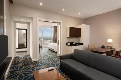 a living room with a couch in a hotel room at Embassy Suites by Hilton Santo Domingo in Santo Domingo