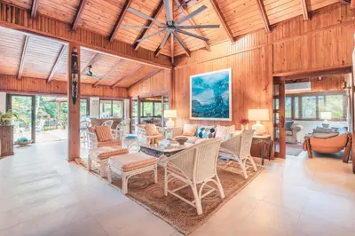 an open living room with a table and chairs at Fun in the sun classic villa at Los Lagos in Casa de Campo in Cajuiles