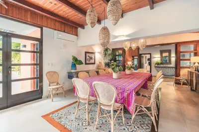 a dining room with a table and chairs at Fun in the sun classic villa at Los Lagos in Casa de Campo in Cajuiles