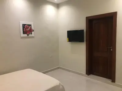 a bedroom with a bed and a television on the wall at Hotel Blue Malecón And Spa in Santo Domingo