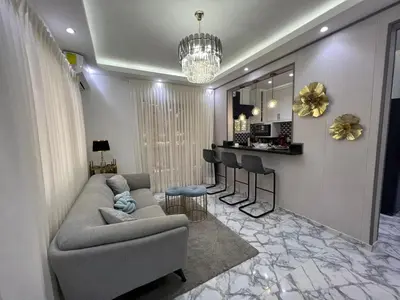 a living room with a couch and a bar at Acogedor apartamento 2 hab Distrito nacional, próximo agora mall in Santo Domingo