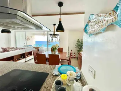 a kitchen and dining room with a view of the ocean at 3 Bedrooms At Marbella Beachfront Juan Dolio in Juan Dolio