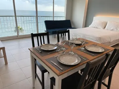 a dining room table with plates and wine glasses at Villa Marbella by Potenza Rentals in Santo Domingo