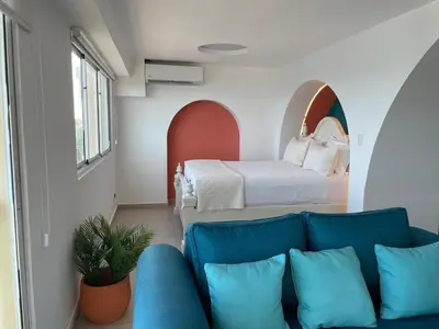 a living room with a couch and a bed at Villa Marbella by Potenza Rentals in Santo Domingo