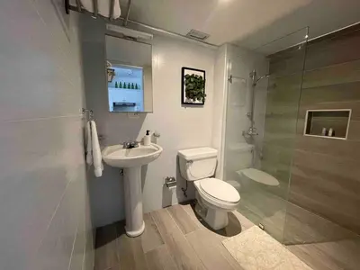 a bathroom with a toilet and a sink and a shower at Villa Marbella by Potenza Rentals in Santo Domingo