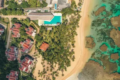 an aerial view of a beach with houses and trees at Beautiful 2 BR apartment at Portillo in Las Terrenas