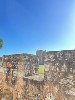 a stone wall with a bench in front of a castle at VBermor Hotel in Santo Domingo