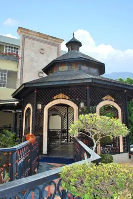 a building with a gate in front of it at Platino Hotel & Casino in Santiago de los Caballeros