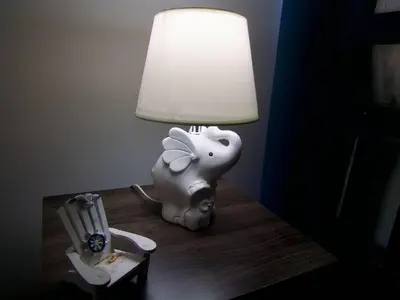 a lamp sitting on a table next to a toy elephant at Lovely condo at Blue Sea Tower near Juan Dolio beach in Juan Pedro
