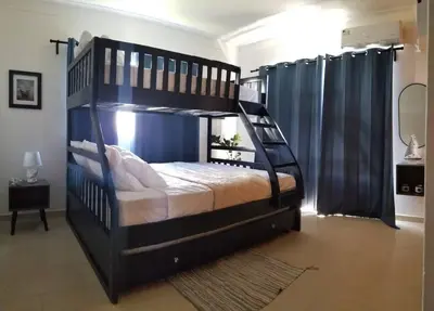 a large black bunk bed in a room with at Lovely condo at Blue Sea Tower near Juan Dolio beach in Juan Pedro
