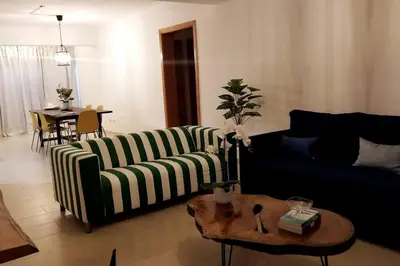 a living room with a couch and a table at Lovely condo at Blue Sea Tower near Juan Dolio beach in Juan Pedro