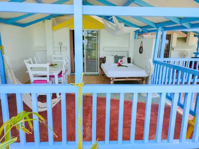 a living room with a blue and white railing at B&B Aparthotel La Isleta in Las Galeras
