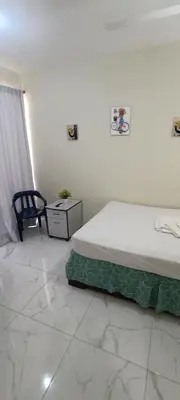 a bedroom with a bed and a chair in it at HEA Stays in San Felipe de Puerto Plata