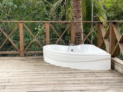 a white bath tub sitting on a wooden deck at VILLA LOMAS LINDAS in La Montosa