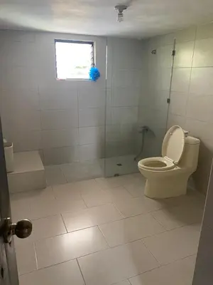 a bathroom with a toilet and a shower and a window at VILLA LOMAS LINDAS in La Montosa