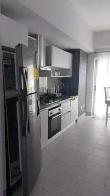 a kitchen with a stainless steel refrigerator and stove at Brickell Hotel apto g 08 Santo Domingo Bella Vista in Santo Domingo