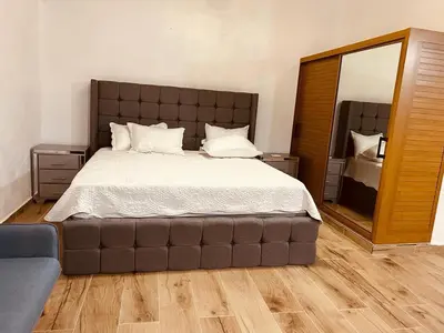a bedroom with a large bed with a large mirror at Villa vista al rio in Jarabacoa