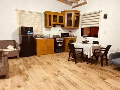 a kitchen and dining room with a table and a kitchen with a table and chairs at Villa vista al rio in Jarabacoa