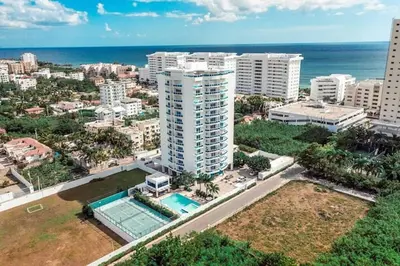 an aerial view of a city with a tall building at Chic and Relax Apartamento Juan Dolio in San Pedro de Macorís