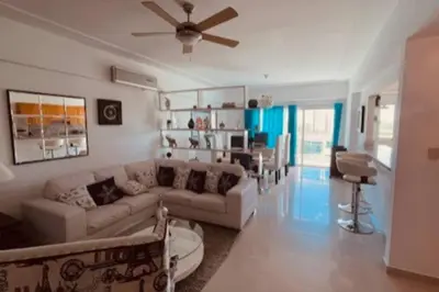 a living room with a couch and a dining room at Chic and Relax Apartamento Juan Dolio in San Pedro de Macorís
