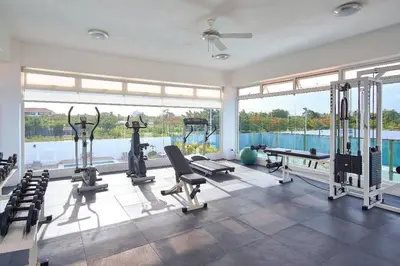 a gym with cardio equipment and a large window at Chic and Relax Apartamento Juan Dolio in San Pedro de Macorís