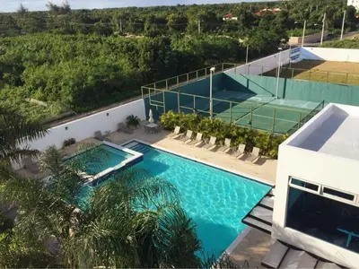 an overhead view of a swimming pool with a tennis court at Elegant Blue Sky View Lux at Juan Dolio Las Velas in Juan Pedro