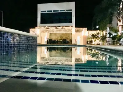 a swimming pool in front of a house at night at Elegant Blue Sky View Lux at Juan Dolio Las Velas in Juan Pedro