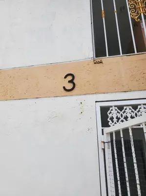 a number on the side of a building with a window at Dominican Suite 23, Incredible 1 Bed Apt (DS23) in San Felipe de Puerto Plata