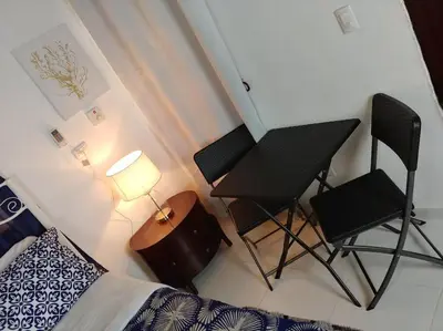 a bedroom with two chairs and a desk and a bed at Dominican Suite 1, Incredible Suite/Studio (DS1) in San Felipe de Puerto Plata