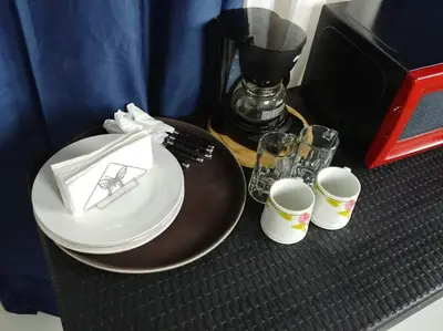 a table with a plate and two cups and a blender at Dominican Suite 1, Incredible Suite/Studio (DS1) in San Felipe de Puerto Plata