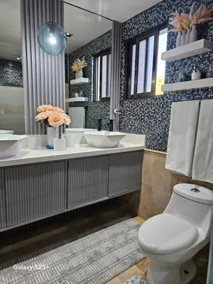 a bathroom with a white toilet and a sink at Luxury apto 3 rooms+pool+ campo de golf. Cocotal in Punta Cana