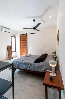 a bedroom with a bed and a ceiling fan at El Valle Villas in Santa Bárbara de Samaná
