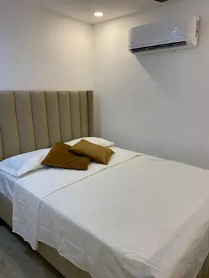 a bed with two pillows on it in a room at Studios Don Bosco in Santo Domingo