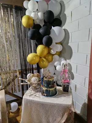 a table with a cake and a bunch of balloons at Hacienda Claro de Luna 3 Bedrooms in Jarabacoa