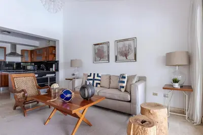a living room with a couch and a table at Fortunity Club- Playa Dorada, Pto Plata in Sampiño