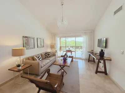 a living room with a couch and a table at Fortunity Club- Playa Dorada, Pto Plata in Sampiño