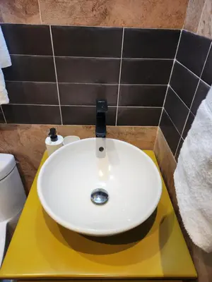 a white sink on a yellow counter in a bathroom at Hotel La Casona MC in La Romana