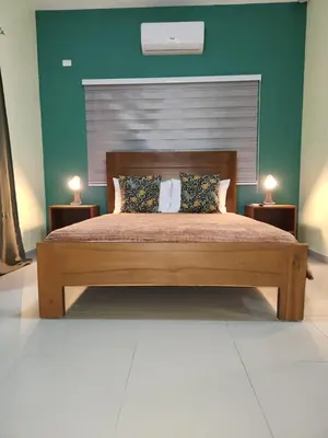 a bedroom with a large bed with two night stands at Hotel La Casona MC in La Romana