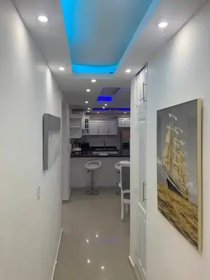 a room with a kitchen and a blue ceiling at Luxury apartment with Pool in Santiago de los Caballeros