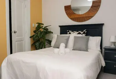 a white bed with a stuffed animal on top of it at Residencial Frank I in Santo Domingo