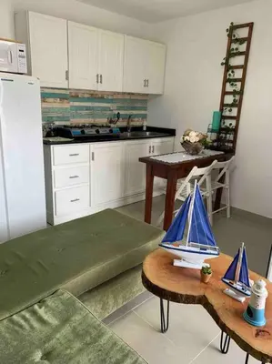 a kitchen with a table with a model boat on it at Juan Dolio apart1 hab in Juan Pedro