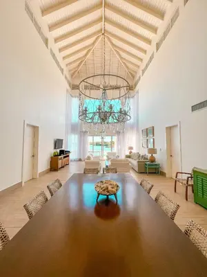 a large dining room with a large table and a chandelier at Peninsula Esmeralda Luxury Hotel & Villas in San Felipe de Puerto Plata