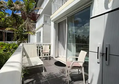 a patio with two chairs and a table on a balcony at Lovely house with private beach in Santa Bárbara de Samaná