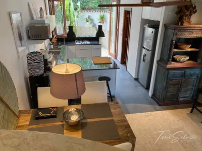 a living room with a table and a kitchen at CABARETE BEACH HOUSES the NANNY ESTATES in Cabarete